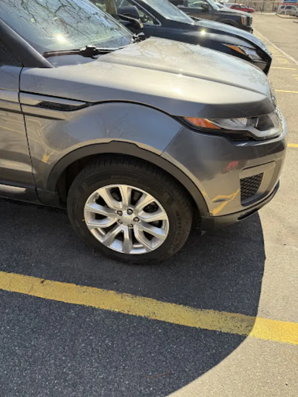 The same Range Rover front fender and wheel arch, straight and refinished after repair
